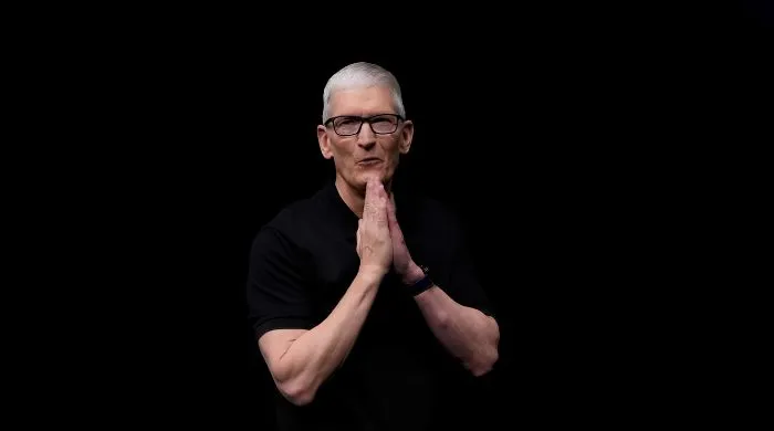 Senior Apple executive in a black outfit with hands clasped, symbolizing leadership transition as the company announces a new CEO after a long-standing tenure.