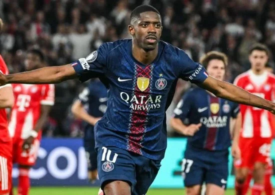 PSG forward celebrates with arms outstretched after scoring in a high-scoring 5-4 win over Bayern Munich, capturing the intensity of the Champions League semifinal thriller.