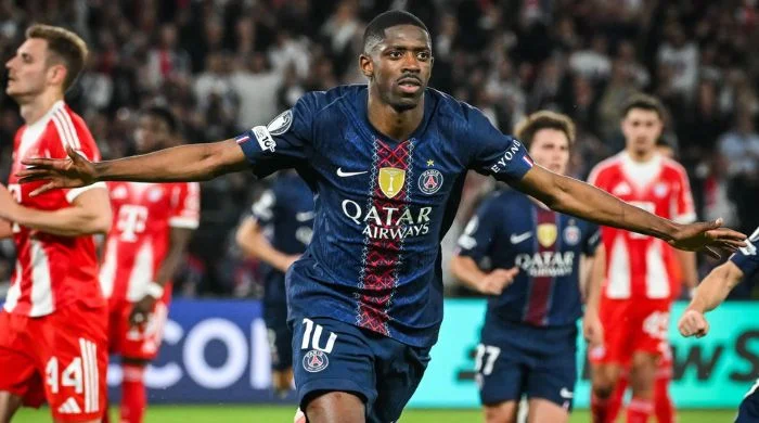 PSG forward celebrates with arms outstretched after scoring in a high-scoring 5-4 win over Bayern Munich, capturing the intensity of the Champions League semifinal thriller.