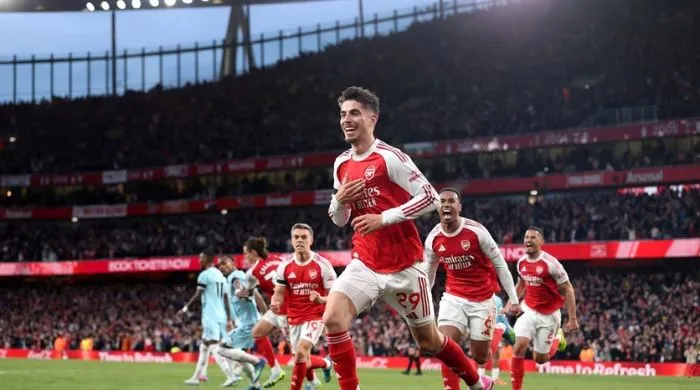 Arsenal players celebrating a goal at Emirates Stadium during the 2025/26 Premier League season, highlighting Max Dowman and teammates after clinching the title.