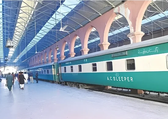 Pakistan Railways passenger train standing at a railway station platform, representing the government’s reported plan to outsource 15 passenger train operations to private operators.