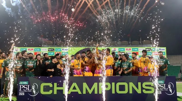 Peshawar Zalmi players and support staff celebrates with the PSL 11 trophy after beating Hyderabad Kingsmen in the final at the Gaddafi Stadium in Lahore on May 3, 2026