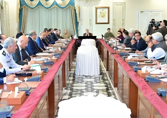 Government officials and ministers seated around a long conference table in Islamabad, discussing the extension of austerity measures and revised business hours until June 30, 2026.