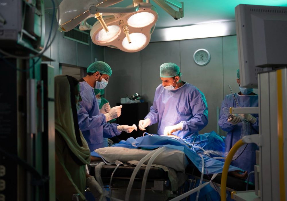 Bariatric surgeon performing a procedure in an operating room, representing medical and surgical treatment options for obesity.