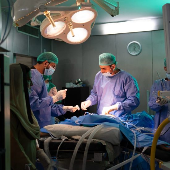 Bariatric surgeon performing a procedure in an operating room, representing medical and surgical treatment options for obesity.