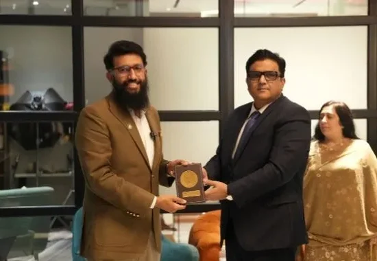 Devsinc representative receives a commemorative shield during the National Institute of Public Administration delegation visit in Lahore.