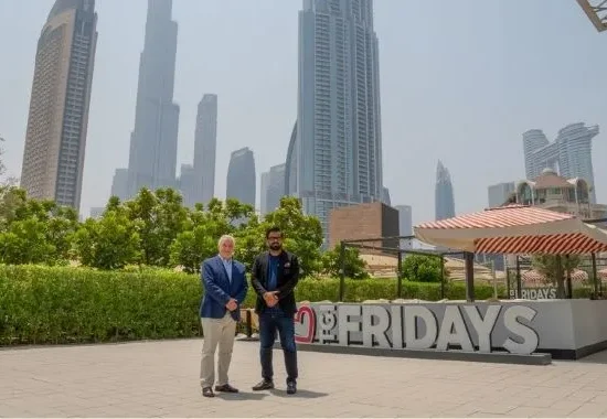 TGI Fridays representatives in front of a TGI Fridays location as the brand announces plans to expand across Pakistan through a development agreement with Meerab Hospitality.
